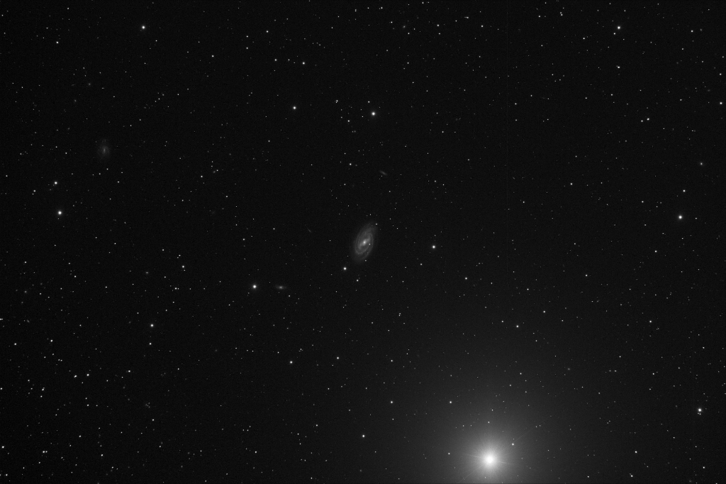 A barred spiral galaxy in the constellation Ursa Major. Pictured next to the star Phecda, the lower-left star forming the bowl of the Big Dipper.  Taken 2014-03-07 with T16, a Takahashi TOA-150, a wide - medium deep field telescope. This hybrid science/imaging platform located at AstroCamp Observatory in Nerpio, Spain
